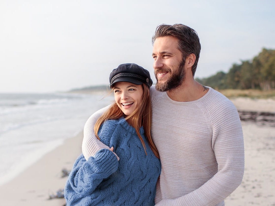 Background Image Of Two Happy People At The Beach