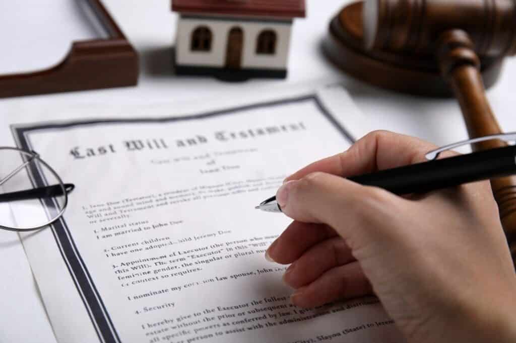 stock photo woman signing last will and testament at white table closeup 2213231163 transformed